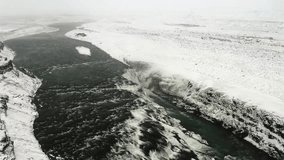 Aerial footage capturing the Hvítá River cutting through the rugged canyon near Gullfoss waterfall during wintertime. - Powered by Shutterstock - Get 15% off with code: PIKWIZARD15