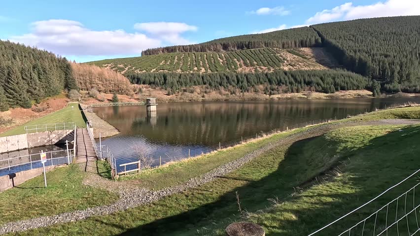 Walking in Glen Devon near Loch Turret Reservoir in Perthshire. Scottish moorland and hills. Mountain range. Grassland, sheep and flowing water. Scotland Highland stream river burn wild places bright 