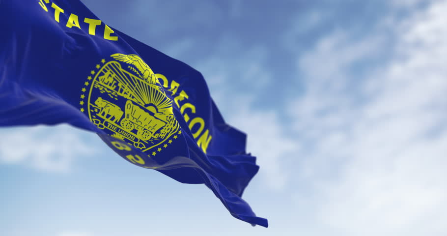 Oregon state flag waving in the sky. Featuring the state seal, eagle, and historical symbols. Seamless 3d render animation. Slow motion loop. Selective focus