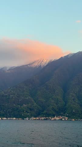 picturesque red sunset over Lake Como Italy with mountain view. Scenic and peaceful Italian landscape, perfect for travel footage, cinematic backgrounds, nature videos, and romantic content