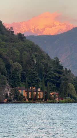 picturesque red sunset over Lake Como Italy with mountain view. Scenic and peaceful Italian landscape, perfect for travel footage, cinematic backgrounds, nature videos, and romantic content