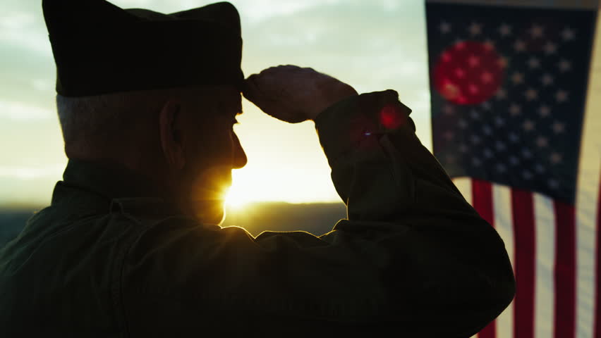 Veteran Soldier Doing The Military Salute To The Flag 