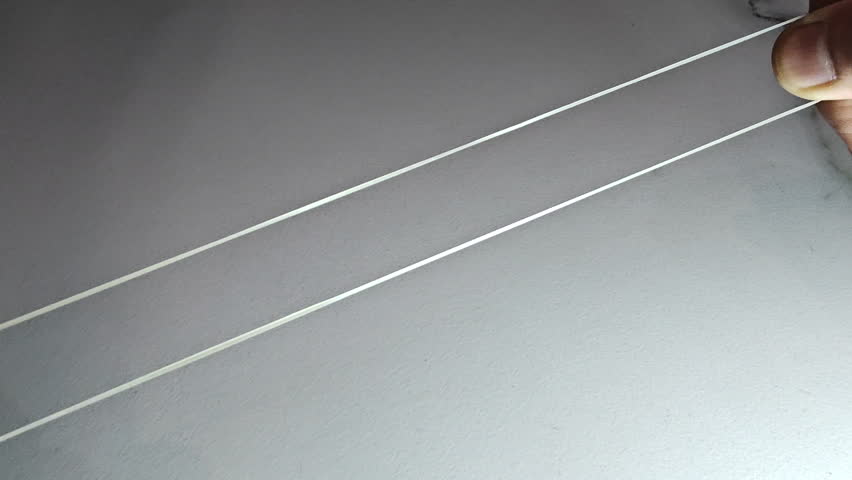 Person stretches a rubber band, New Delhi, Delhi, India