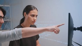 Two developers collaborating coding and software tasks modern workspace, utilizing teamwork and technology with programming computer monitor and tablet for coding developer software programmer code - Powered by Shutterstock - Get 15% off with code: PIKWIZARD15