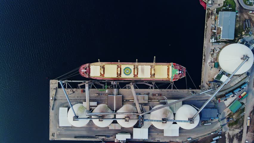 Bulk Cargo Vessel Docked at Industrial Grain Terminal - Dramatic Top Down View