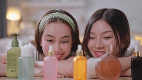 Two young Asian happy girls do make up skincare routine with beauty product in living room at home - Powered by Shutterstock - Get 15% off with code: PIKWIZARD15