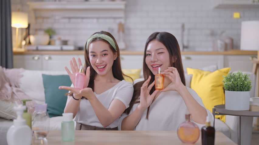 Two young Asian beauty influencer live-streams and reviews cosmetics for her online audience.