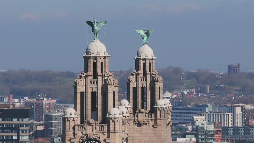 Sweeping aerial view of Liverpool's skyline, highlighting the Royal Liver Building, clock tower, and a mix of historic and modern architecture.
