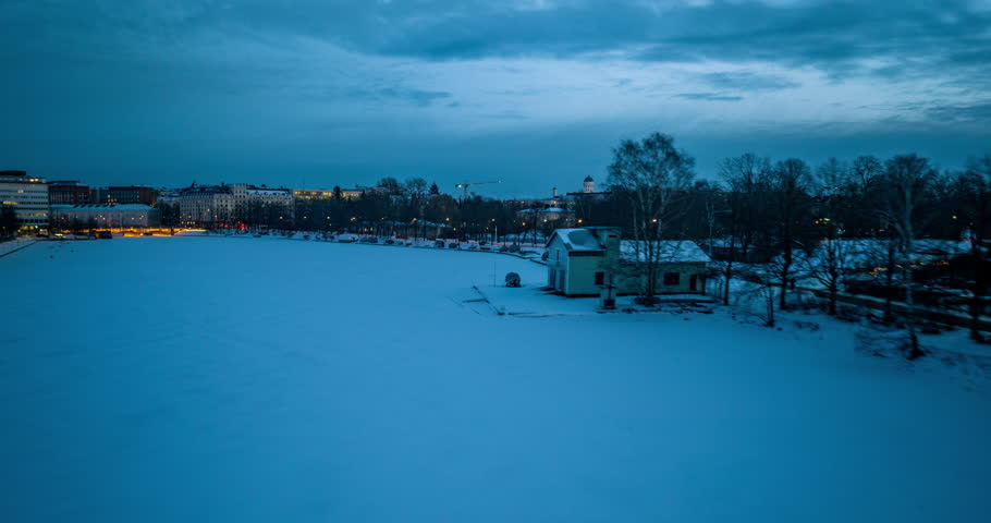 Aerial hyperlapse in front of Kaisaniemi park and Helsinki cathedral, winter dusk