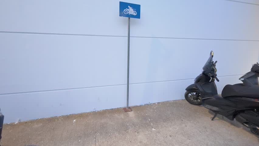 Blue Signs Indicating a Parking Lot Reserved for Motorbikes