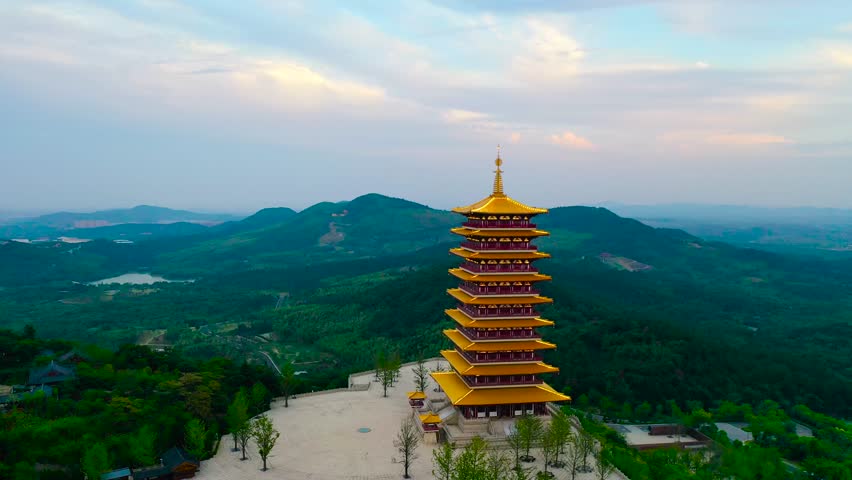 Golden Hour Silhouettes of Pagodas Against Misty Mountains