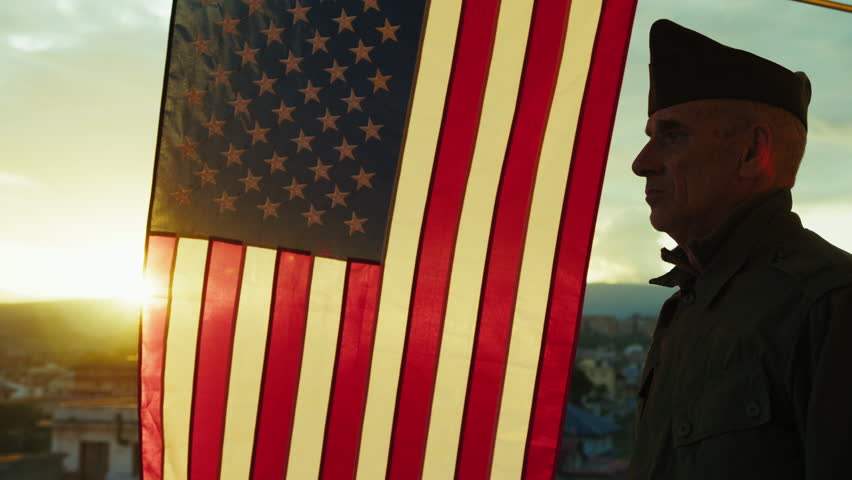 Sunlight Over The Flag And The Veteran Soldier