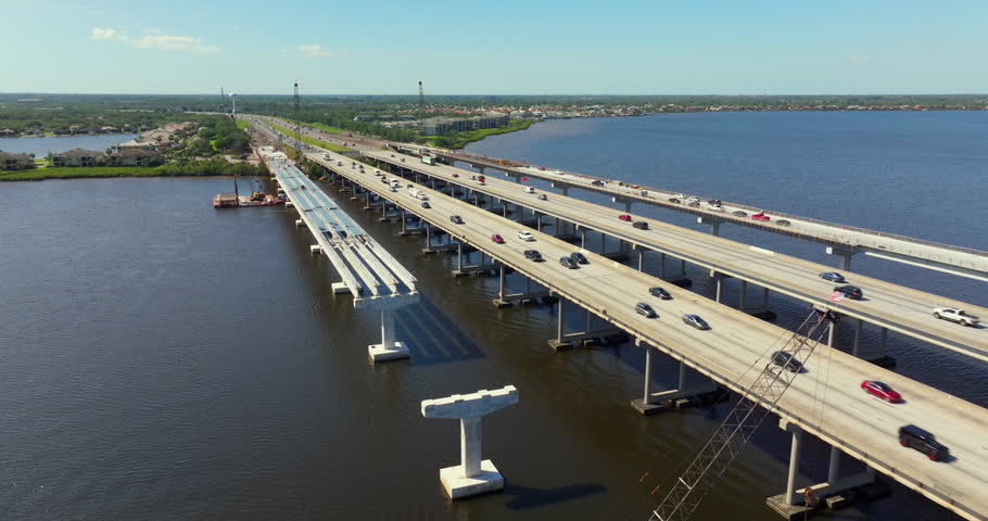Driving traffic cars on freeway bridge road under construction. Building traffic infrastructure on American roadway.