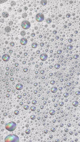 Foam background. Liquid soap bubbles, Froth bubbles backdrop. Soap foam popping bubble rotating, white backdrop. Soap sud macro structure close-up. Clean, cleaning, washing, laundry