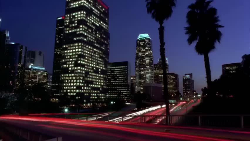 Time Lapse Transition from Day to Night with Skyscraper and High motion Traffic