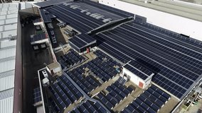 Solar panels installed on industrial building roof generating renewable energy - Powered by Shutterstock - Get 15% off with code: PIKWIZARD15
