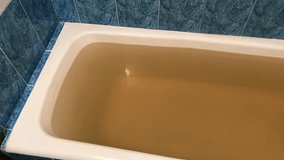 Dirty Brown Water in Bathtub - Contaminated Tap Water Problem in Home Bathroom - Water Pollution Issue in Residential Plumbing System - Powered by Shutterstock - Get 15% off with code: PIKWIZARD15