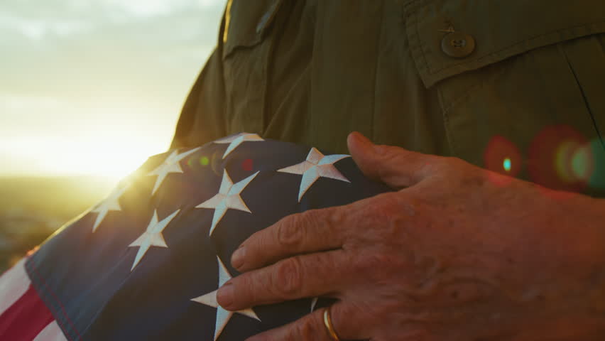 Veteran Holding And Caressing The Stars Of US Flag 