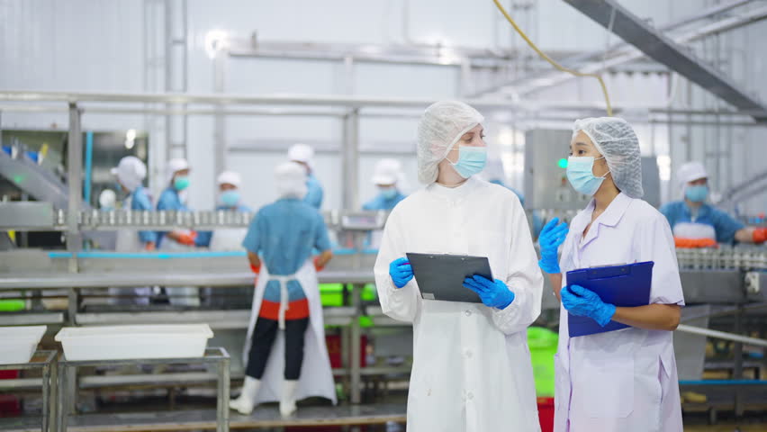 Canned food manufacturing factory industry. Quality control officer inspecting production line. Worker preparing sardines packaging into aluminum cans. Processed food production business entrepreneur.