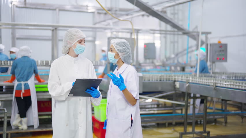 Canned food manufacturing factory industry. Quality control officer inspecting production line. Worker preparing sardines packaging into aluminum cans. Processed food production business entrepreneur.