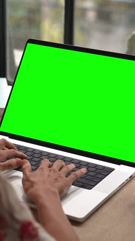 Business Woman Working at Laptop Computer with Green Screen Chroma Key for Mockup. Typing Text on Keyboard or Talking in Internet Messages. Student Studies Homework Content or Speaks Online at Website