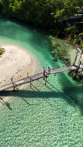 Discover a breathtaking landscape in Thailand featuring a serene river with a wooden bridge at Koh Kood Island