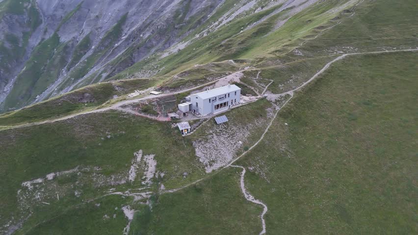Orbit flight around alpine hut Cabane de la Tourche with mountain panorama in the morning in Swiss Alps, Switzerland