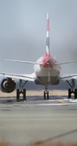 Distant view of a commercial aircraft descending for landing, framed against a moody sky and runway lights.. documenting commercial air travel and transit atmosphere