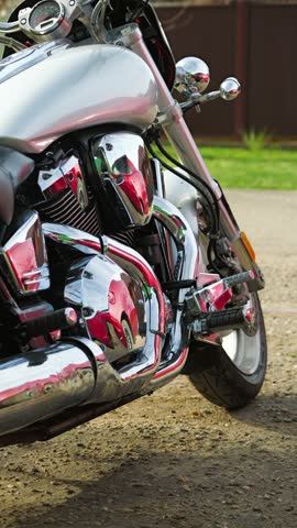 Closeup of gray heavy duty road motorcycle with chrome details. Powerful cruiser motorcycle with v-twin engine. Classic style
