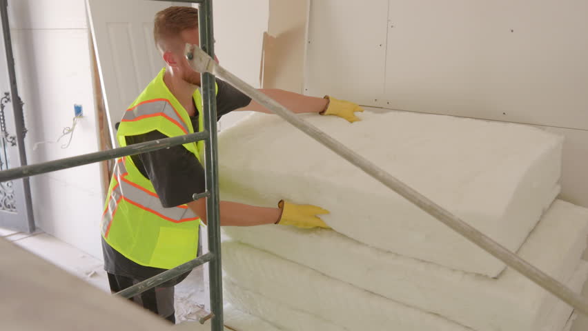 Caucasian builder works efficiently with tools at a construction site, planning a new house renovation. Their dedication and teamwork highlight the spirit of construction.