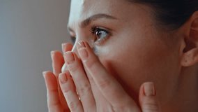 Closeup girl touching facial smooth skin at morning skincare routine. Portrait attractive young lady massaging face for mimic wrinkles prevention. Serious brunette looking natural beauty in bathroom. - Powered by Shutterstock - Get 15% off with code: PIKWIZARD15