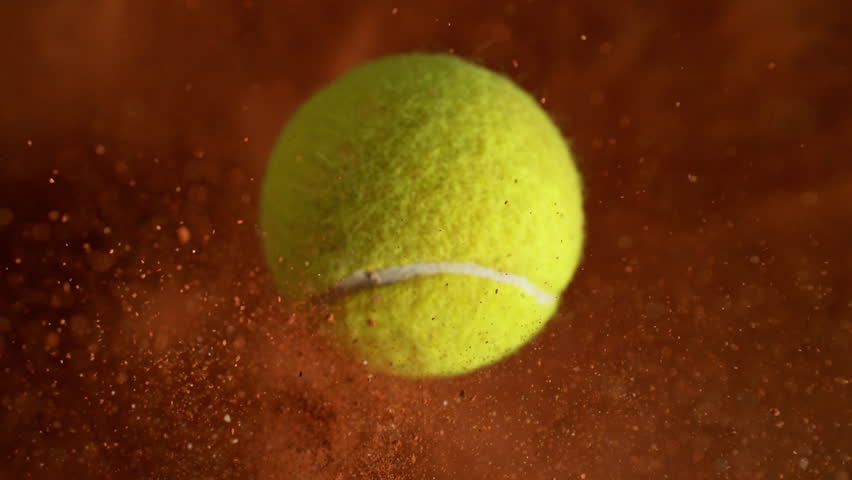 Super Slow Motion Flying Tennis Ball and Orange Clay Explosion Towards Camera at 1000fps.