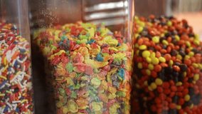 Glass jars filled with colorful cereal, chocolate candies, and sprinkles, ready for dessert toppings - Powered by Shutterstock - Get 15% off with code: PIKWIZARD15