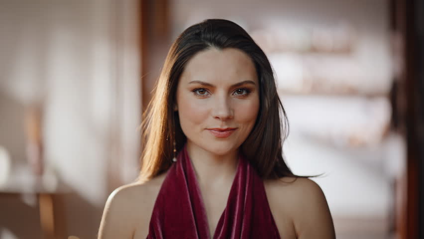 Elegant model adjusting hair looking mirror closeup. Smiling gorgeous woman in chic dress admiring reflection ready for party. Beautiful luxurious lady enjoying stylish appearance prepared for meeting