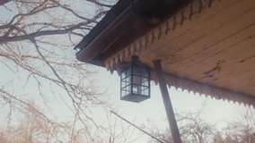 Old Lantern Hangs Under Fading Eaves on a Cold Estonian Morning - Powered by Shutterstock - Get 15% off with code: PIKWIZARD15