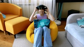 Young girl enjoys immersive gaming experience while seated in cozy living room with vibrant furniture - Powered by Shutterstock - Get 15% off with code: PIKWIZARD15