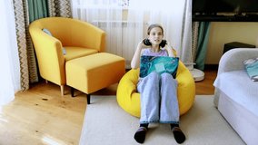 Young person enjoying gaming in a cozy living room with bright furniture on a relaxed afternoon - Powered by Shutterstock - Get 15% off with code: PIKWIZARD15
