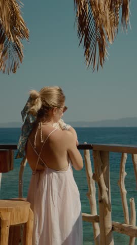 Vertical Screen: Loving maternal bond unfolding near ocean waters, peaceful baby and mom sharing warm sunny moments during tropical vacation