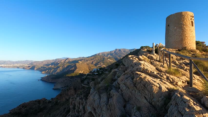 Sunrise over Mediterranean sea. Historic Torre Vigia De Cerro Gordo, a watchtower looking out for any marauding pirates. La Herradura, Andulasia, Southern Spain