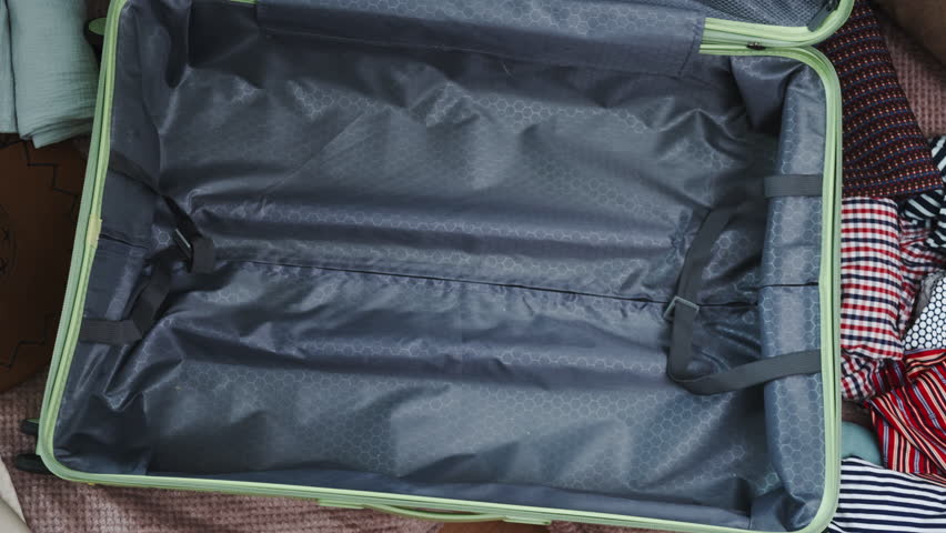 Timelapse. Packing clothes into suitcase for vacation. Traveling. Preparing for summer trip.