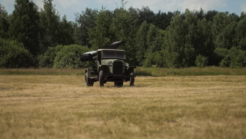 Soviet Katyusha multiple rocket launcher Vehicle drives across field in Great Patriotic War Reenactment. legendary Red Army rocket artillery system military vehicle. Iconic BM-13 mounted on truck