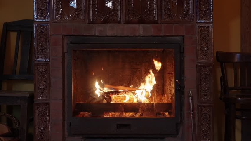 Wood burning in the fireplace in the interior of old European house