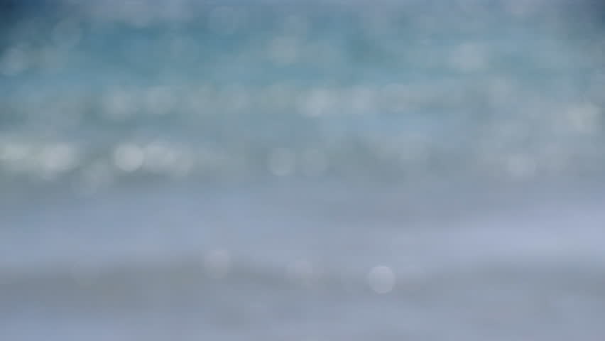 Sea. Blue sea water, waves with white foam and sandy beach. Summer sunny day. Seashore sea coast seascape. Nobody. Blurred background. Natural abstract background. Nature blurry backdrop.