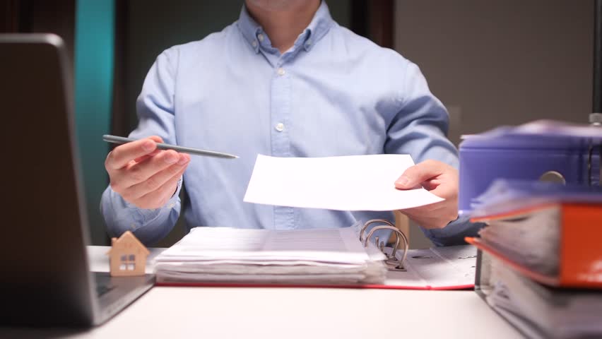Real estate agent showing contract and giving pen for signing agreement