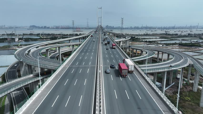 Multi-level bridge China. Cars drive transport interchange. Road traffic. Chinese ship sails, freight cargo logistic. Aerial top drone view, fast urban highway. Modern city freeway. Shipping delivery.