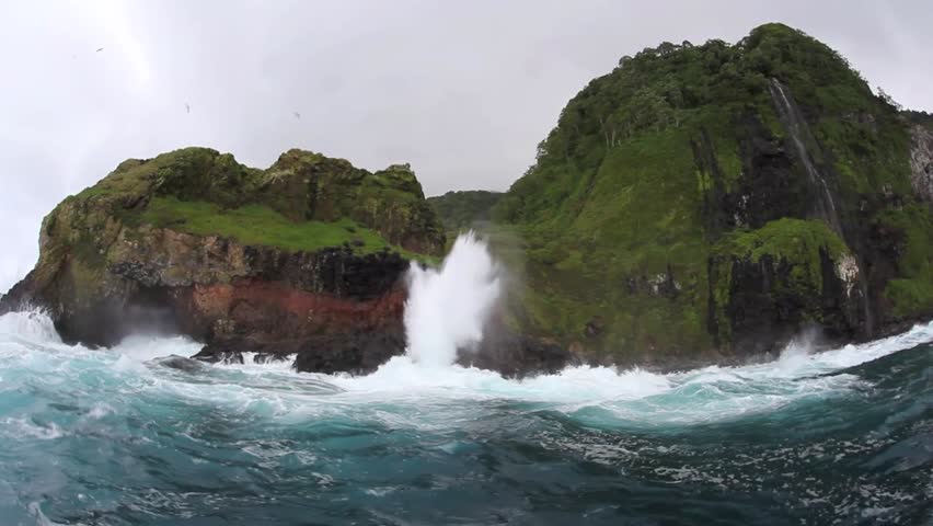 Sea water shoots up a blow hole on the rugged coast of Cocos Island, Costa Rica.