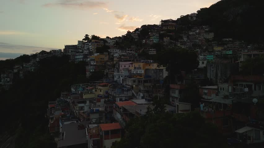 Aerial ascend revealing the sunset over colorful Favela Vidigal in Rio de Janeiro