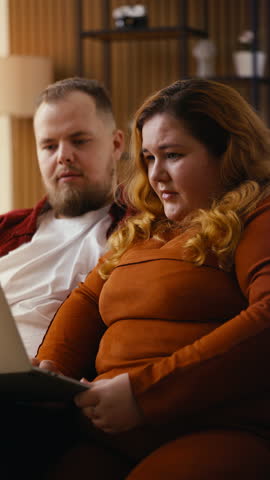 Joyful couple reacting to exciting news, embracing each other and laughing