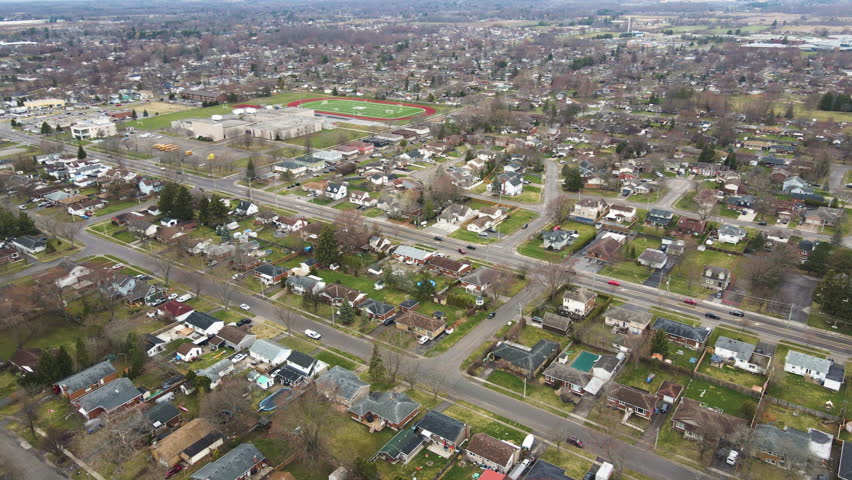 Welland, Ontario, Canada - A Quiet Suburb With Tree-lined Streets, Single-family Homes, and a School With a Football Field. - Aerial Drone Shot