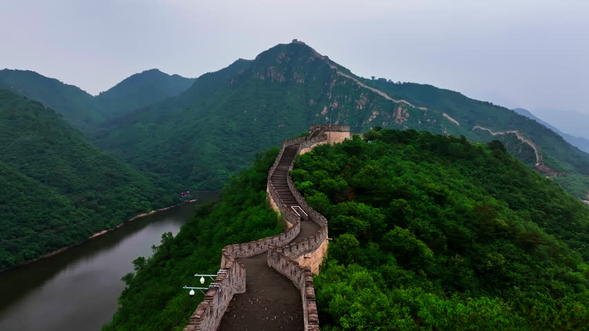 Drone flying backwards along the Great Wall of China, summer day in Beijing